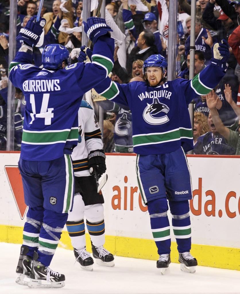 Henrick Sedin and Alexandre Burrows celebrate a goal against San Jose in the Western Conference Finals
