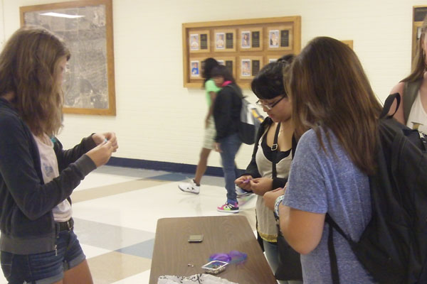 To raise awareness about the effects of depression, members of Erikas Lighthouse passed out purple and blue ribbons to students before school on Wednesday.