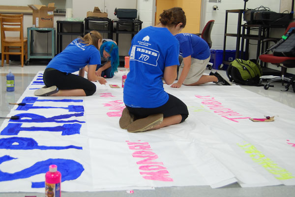 Student Association members work on the banner to decorate homecoming. 
