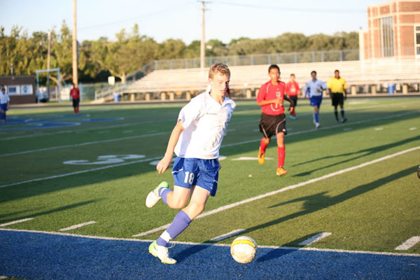 Sophomore James Kaczmacyk dribbles the ball up the sideline.