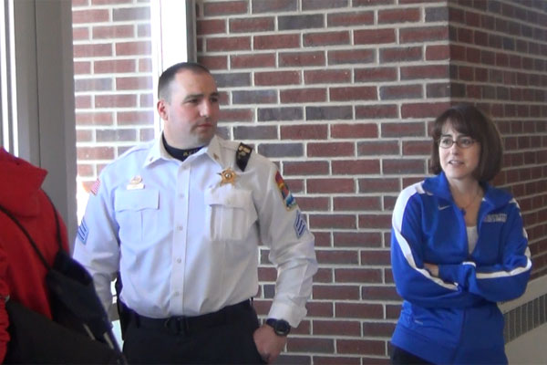 Principal Pam Bylsma stands next to an area police officer as students exit after last weeks soft lockdown.  Bylsma is leaving RB at the end of June to become an assistant superintendent for the Hinsdale 86 school district.