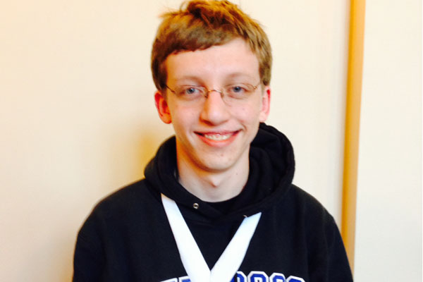 David Buksa smiling after the State Math Competition while wearing his medal.