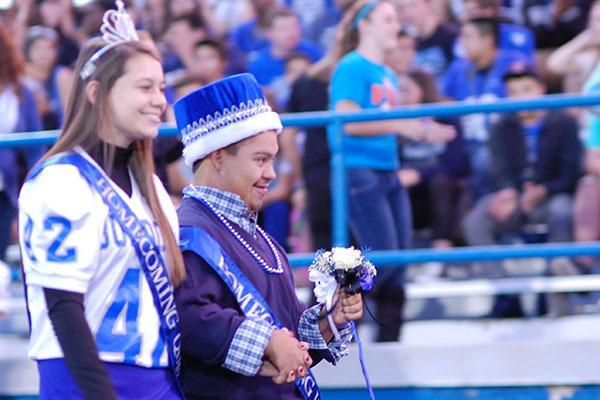 Homecoming Queen, Kate Kosner, and Homecoming King, Josh Sylvie, walking to their seats before the game. 