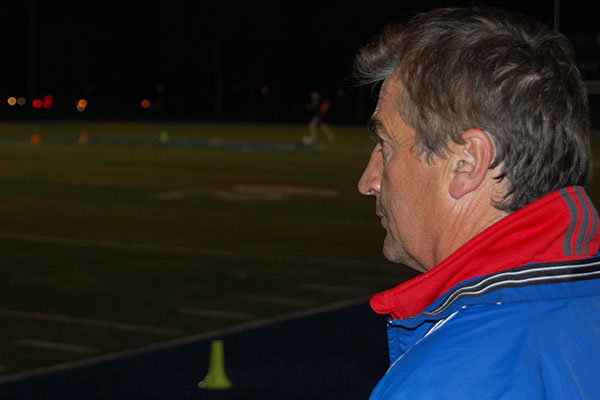 Soccer Coach Danny Makaric looks on as the boys team practices. Many of the athletes have known Makaric from a young age.