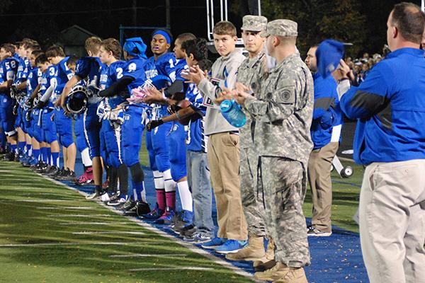 Staff Sergeant Courts and Ahumada take the field with the RB football team and band.