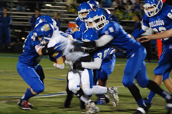 Bulldog defense taking down the Aurora Central runningback.