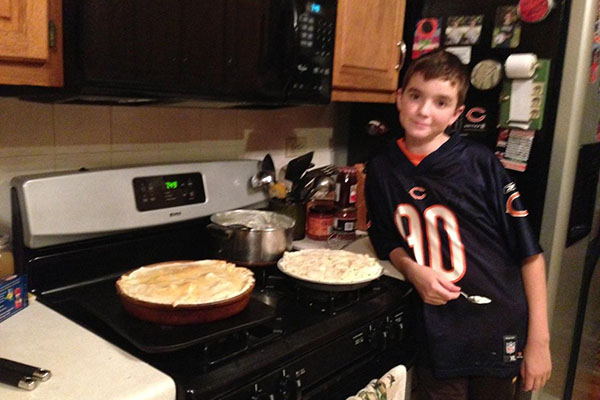 Freshman Erik Robertson poses by his stove at home.  Robertson loves to cook and even plans to become a chef after school.