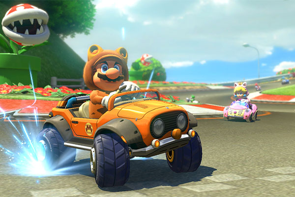 Tanooki Mario and Cat Peach race along Yoshi Circuit, a returning course from Mario Kart: Double Dash. The track and the characters are new with the DLC set.