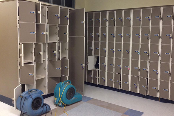 Two heavy duty fans work to dry out music lockers.  Lockers and instruments were damaged when a pipe burst, flooding the area.  The flood occurred the first weekend back from Winter Break.