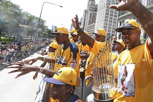 Jackie Robinson West coach Darold Butler and his players celebrate this summer after their US championship.  The team was recently stripped of its title after it was revealed that the team extended its boundaries to add players to its roster.