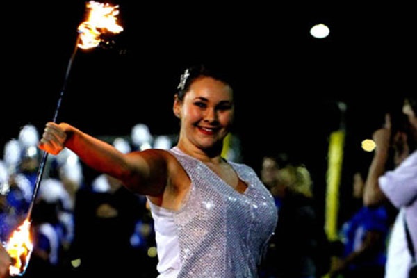 Senior Natalie O'Callaghan twirls fire baton at RB's Homecoming.  Whether twirling or planning to teach, O'Callaghan loves the feeling of being on stage.