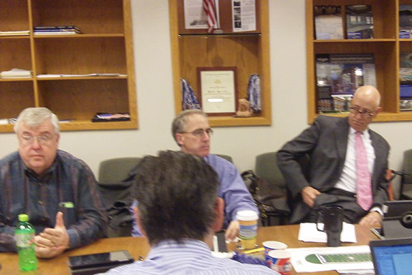 Board members Matt Sinde, John Keen, and Ed Jepson prepare for an early morning special meeting.  The Board voted to sue the Village of Brookfield over the rejection of their parking plan at the close of the meeting.