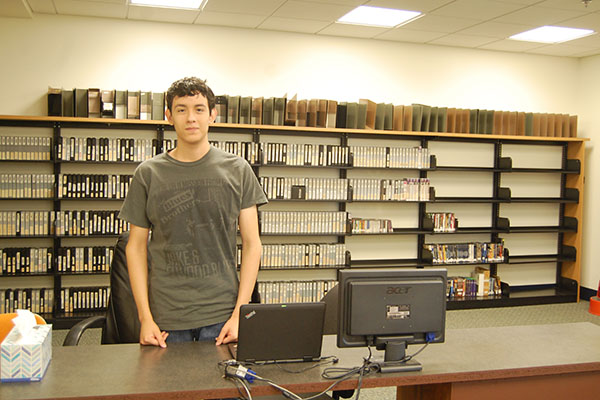 Senior Andy Garcia poses at the help desk.