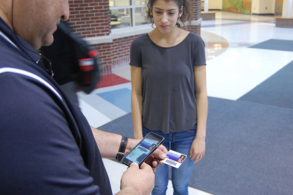RBHS student who arrives late to school has her ID scanned to receive a HERO pass. 