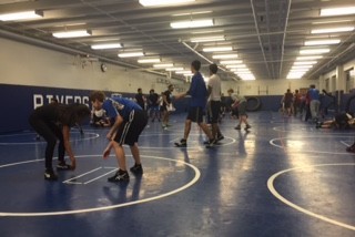 Wrestling practices their techniques. 