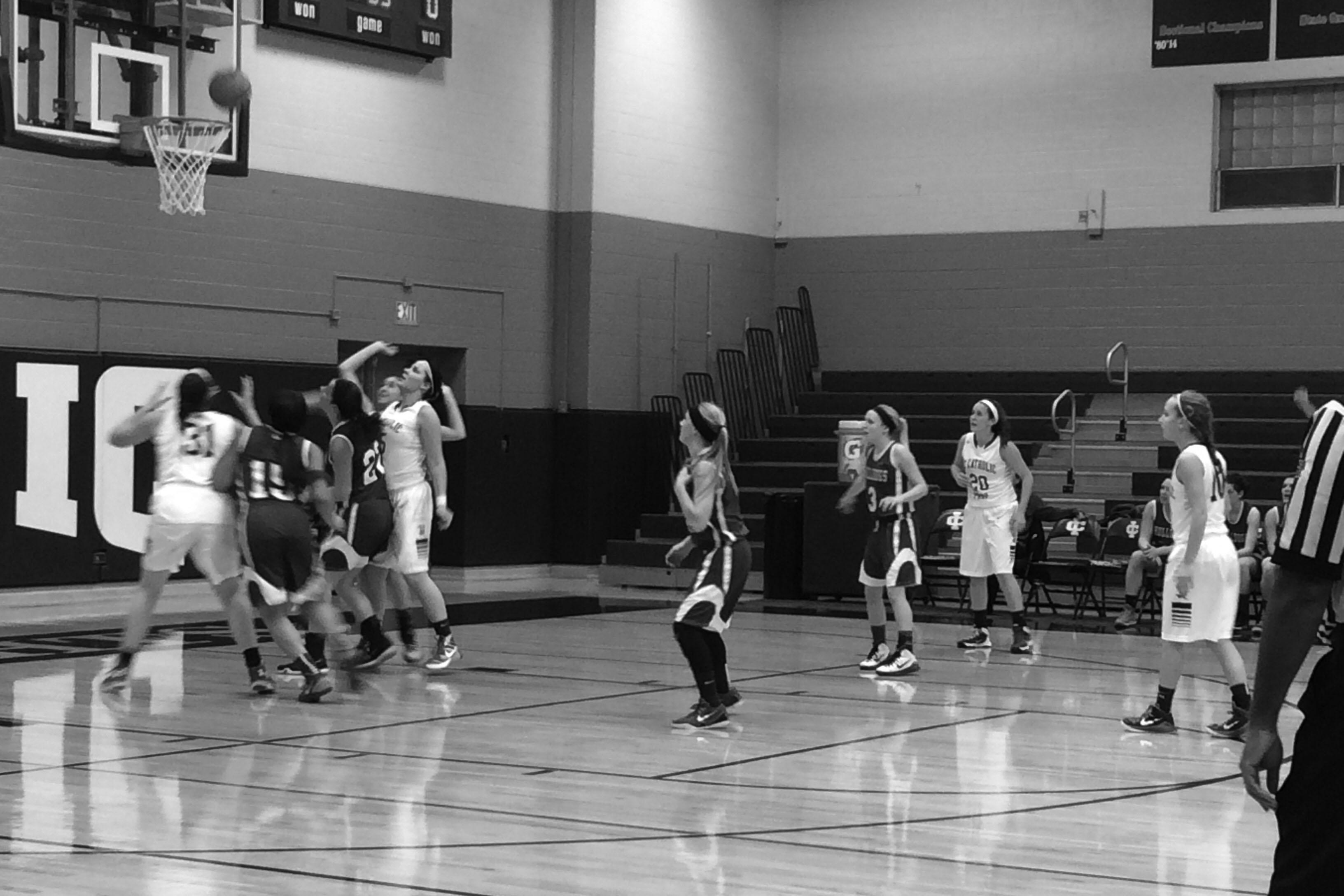 Girls basketball playing hard against ICCP.