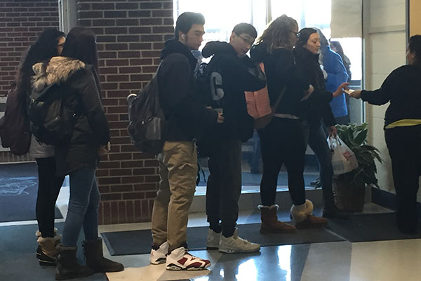 Students wait in line to get their HERO pass.
