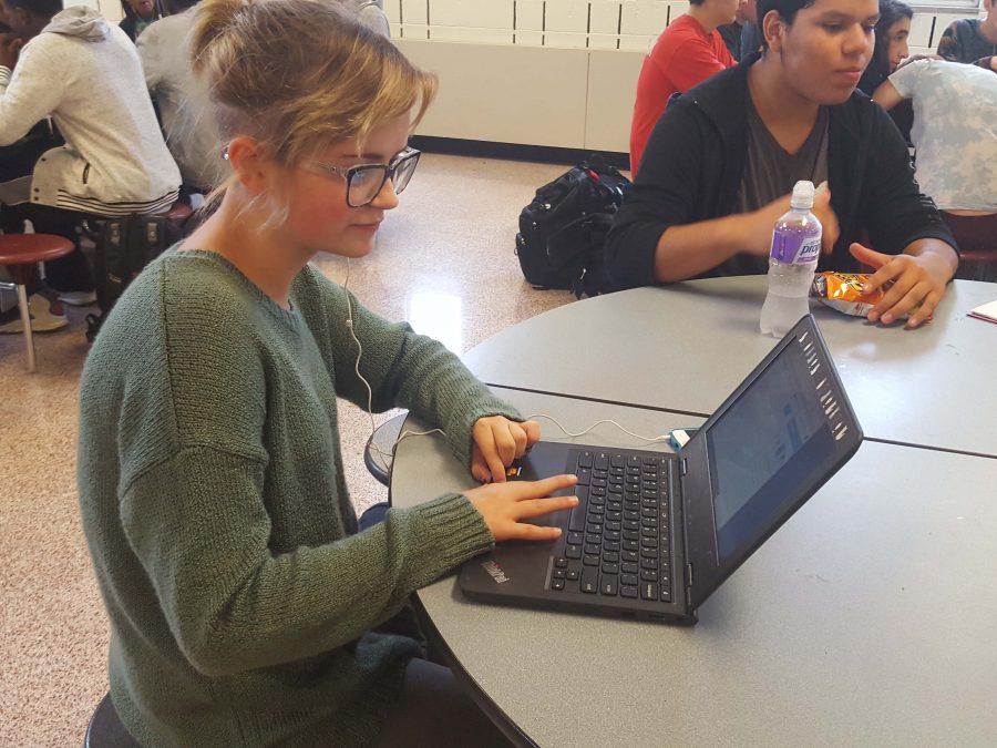 Sophomore, Sophia Doty, working on homework on her chromebook during lunch. 