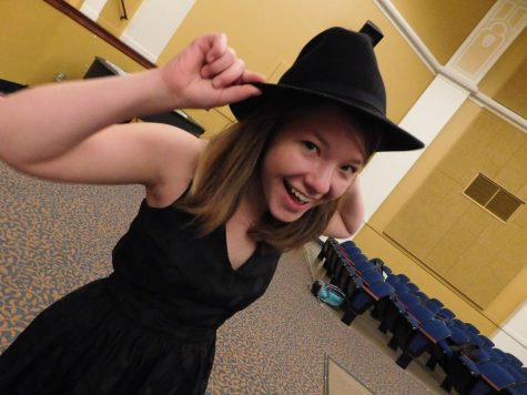 Cameron tries on her costume for the play.