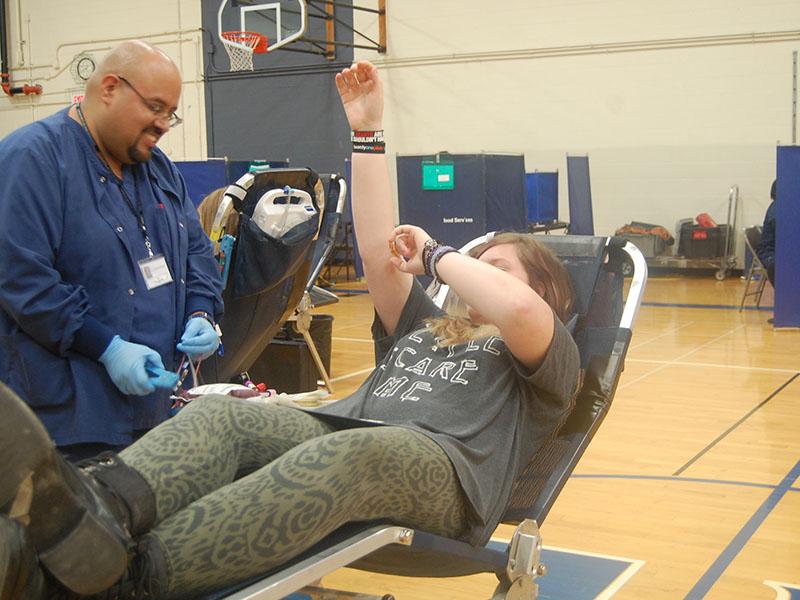 A student raises her arm to avoid fainting during a previous RBHS blood drive in November 2016.