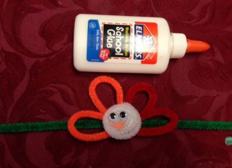 Glue the pipe cleaner to the turkey body 