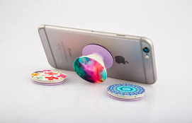 iPhone being held up by a PopSocket