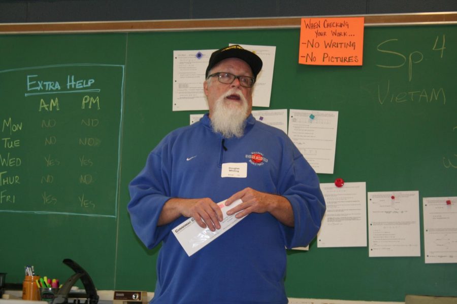 Veteran talks to a group of high school seniors.