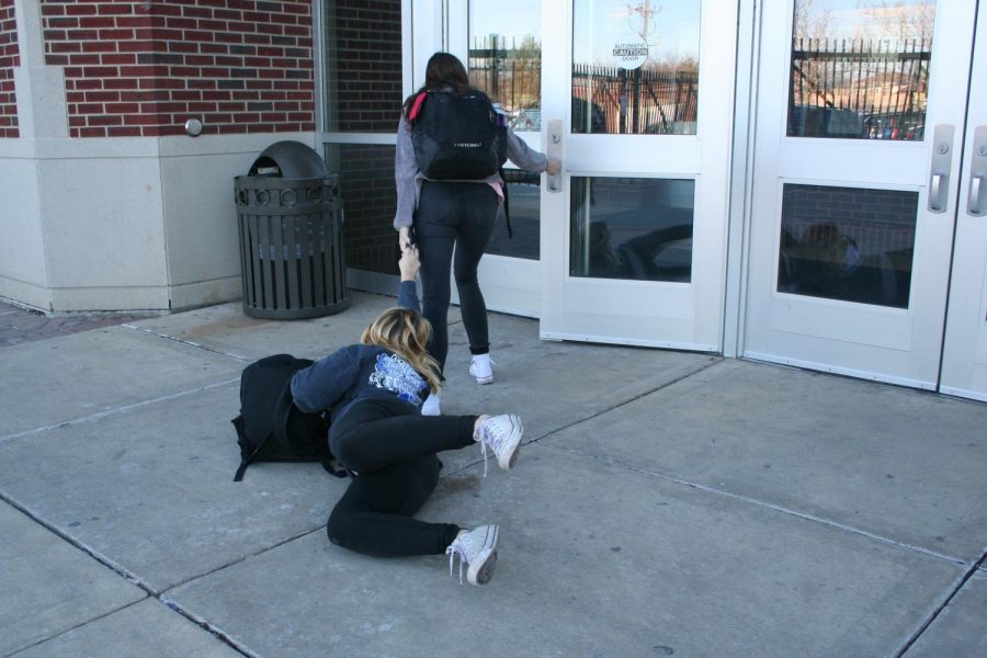 One student dragging in another student after break. 