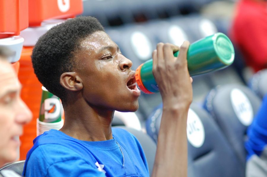 Reggie Loury takes a drink of water during a timeout.