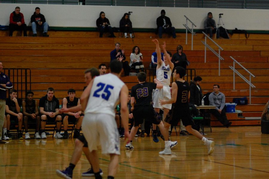 Patrick Hanley shoots in front of Rolling Meadows defenders.