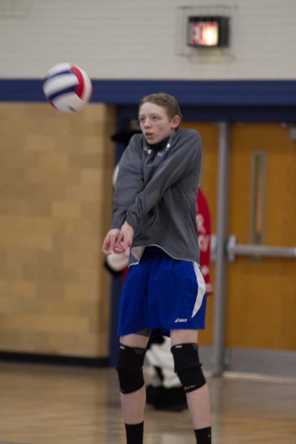 DJ Degand passing a volleyball in warmups vs. Morton