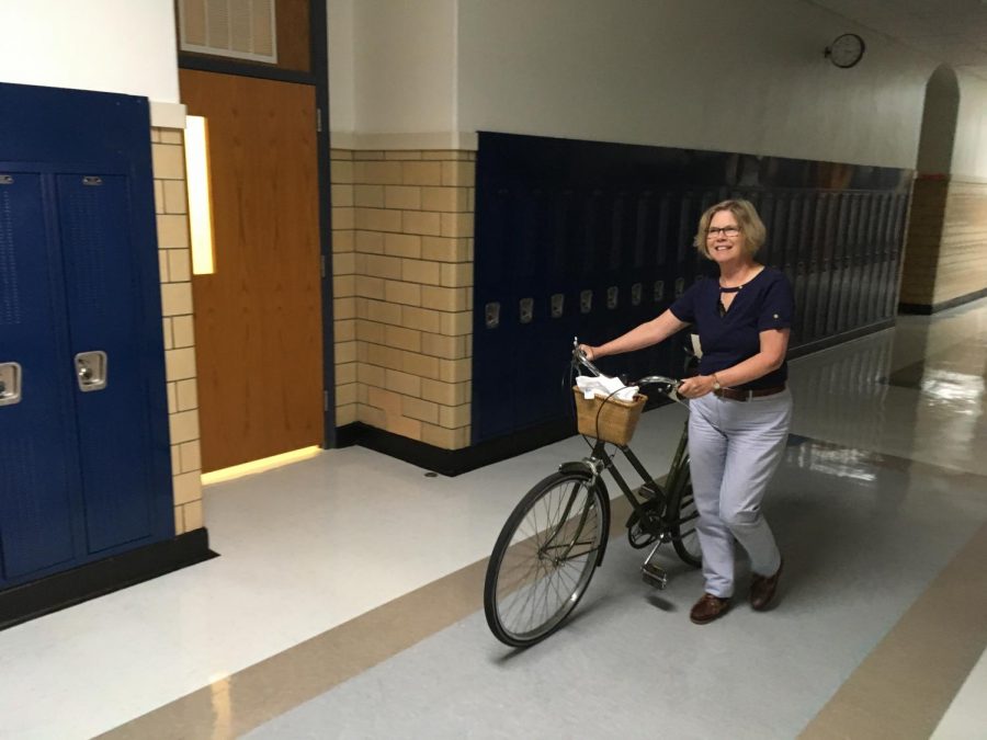 Noelle Bajohr walks her bike through the halls as she heads home for the day.