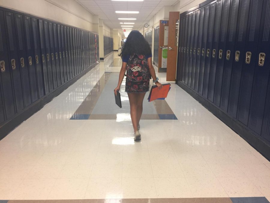 Freshman Sofia Ortiz walking to one of her classes with her Chromebook and her other books.