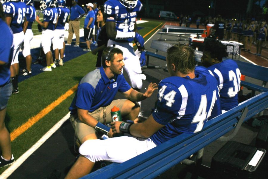 Coach William Duffy talking to players on sideline