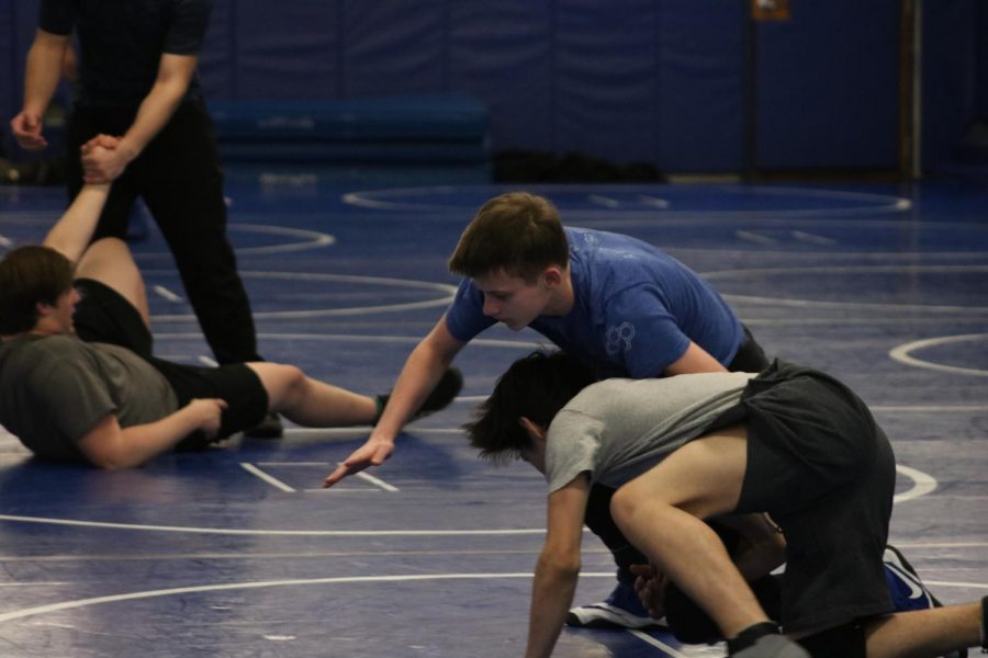 Two wrestlers practicing in preparation for their Sectionals competition, including state qualifier Quintin Godlewski.