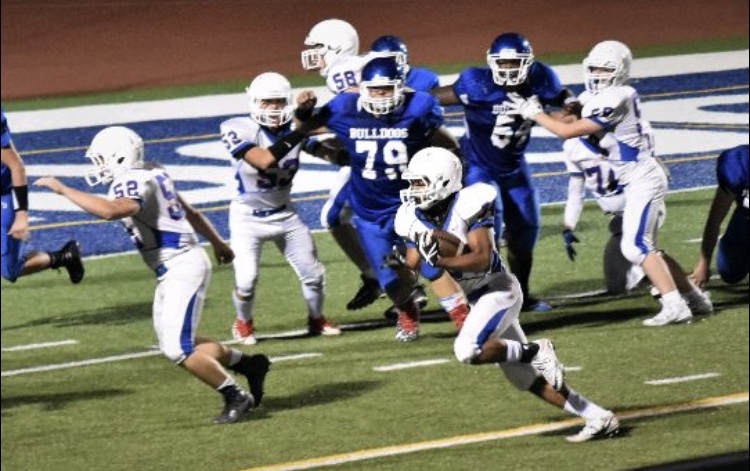 Angel Hernandez, wearing number 79, chasing down his opponent during a game.