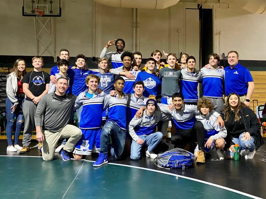 RB wrestling team posing after winning to advance to State.