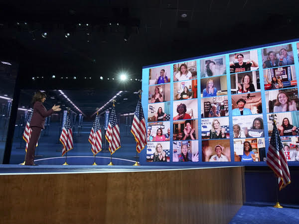 Senator Kamala Harris, Democratic vice presidential nominee, left, claps with viewers watching virtually after speaking during the Democratic National Convention at the Chase Center in Wilmington, Delaware, U.S., on Wednesday, Aug. 19, 2020. Harris's prime-time speech is the first glimpse of how Joe Biden's campaign plans to deploy a history-making vice presidential nominee for a campaign that has largely been grounded by the Coronavirus. Photo taken from Google Images.