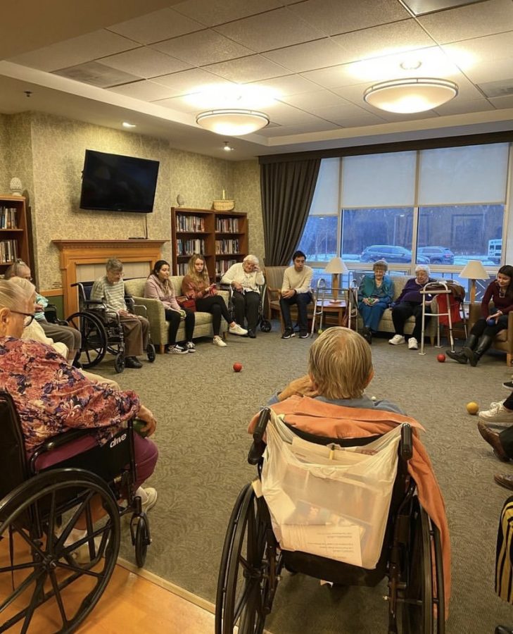 Students gather with the residents of Cantata (taken pre-pandemic). Photo courtesy of John Beasley.