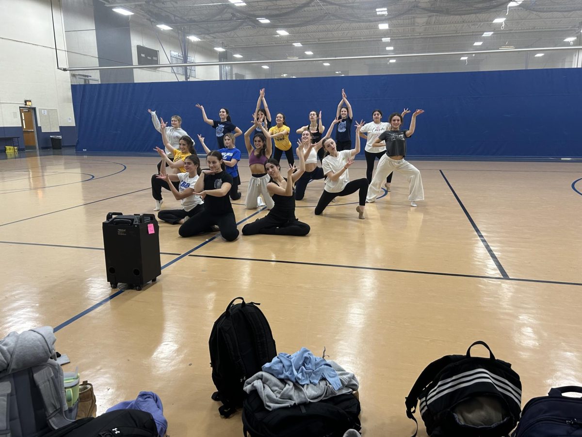 Varsity poms team rehearsing one of their dances in the Field House.