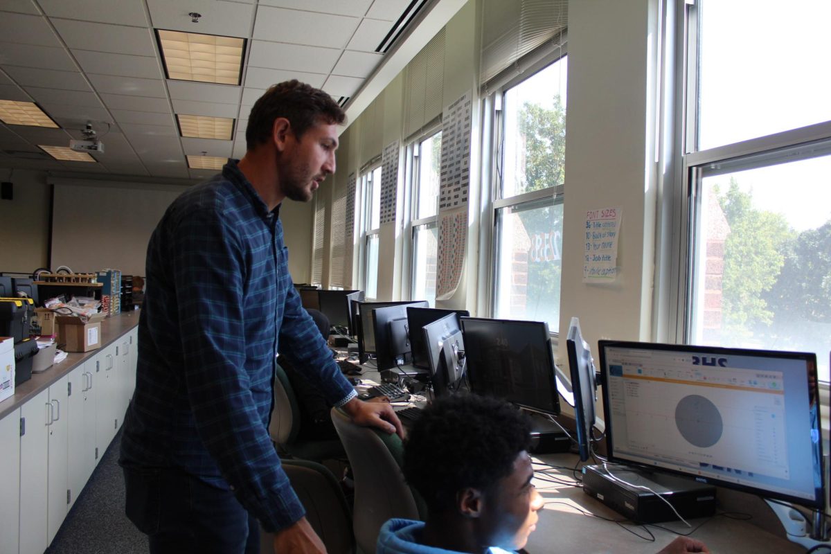 Olson helps students with classwork.