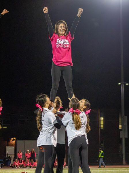 Cheer team stunting at senior night. 