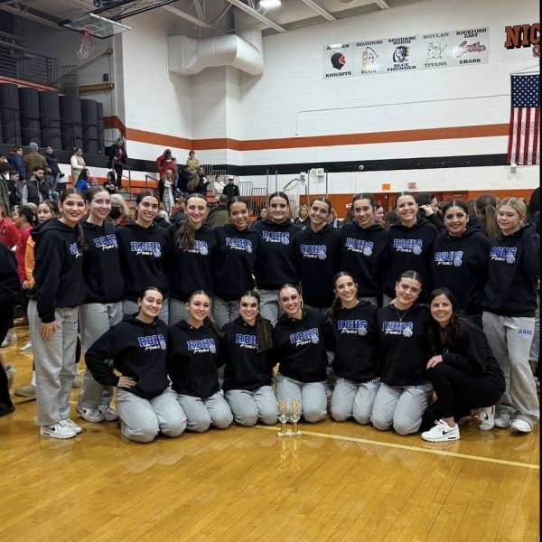 Varsity Poms team posing for a photo at a competition. Photo courtesy of Charlotte Kalnes.  