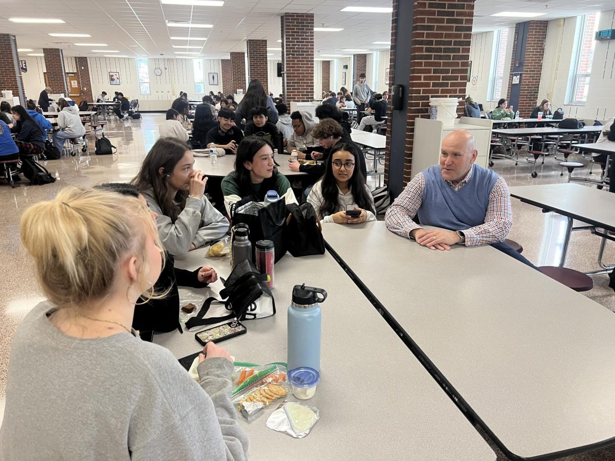 Dr. Kevin Skinkis at lunch table with students.