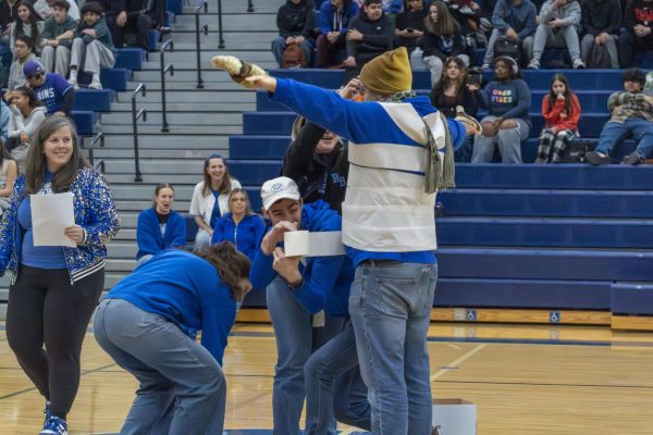 Teachers participating in a snowman game during the pep rally.